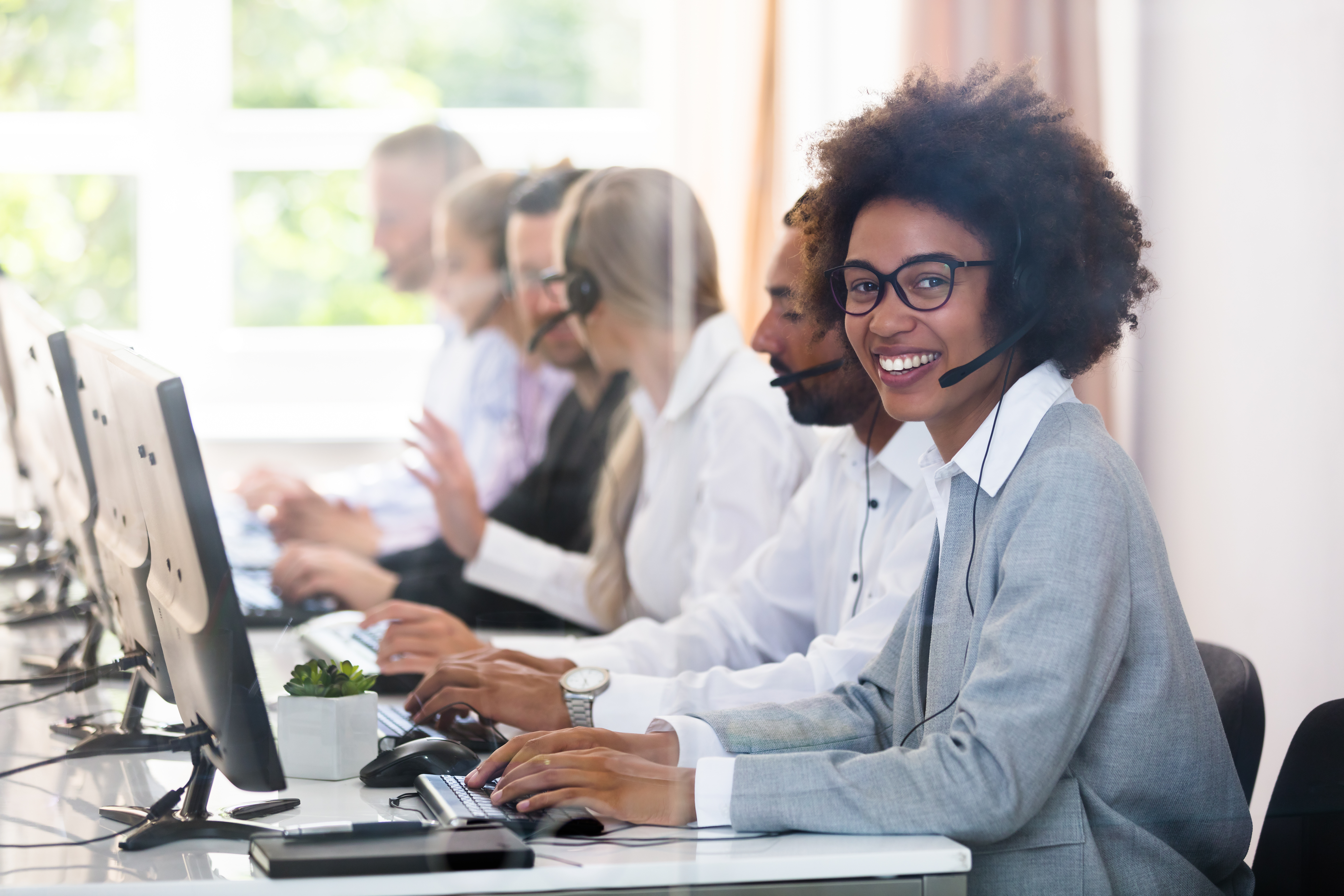 Call center representatives providing phone support to customers with a non-English language preference through a professional interpreter.