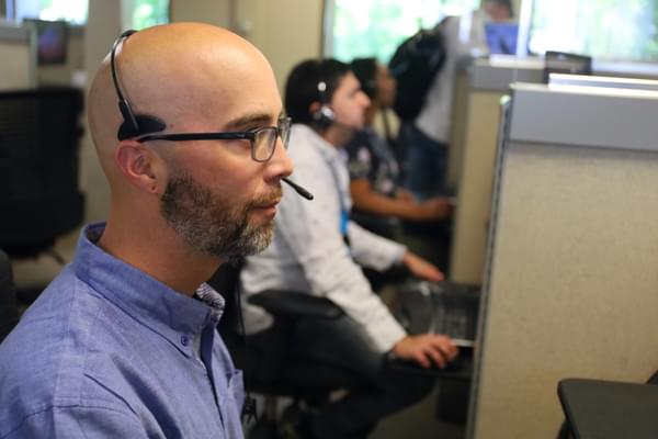 An efficient insurance agent speaks with a customer through an interpreter.