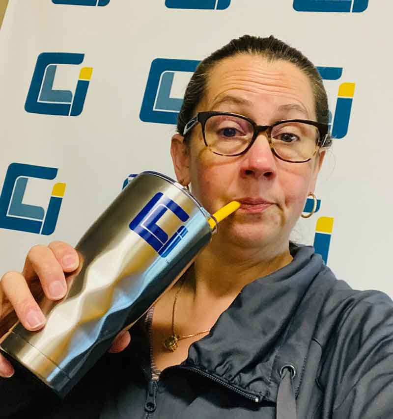 CLI's director of HR takes a selfie while sipping on a coffee through a straw