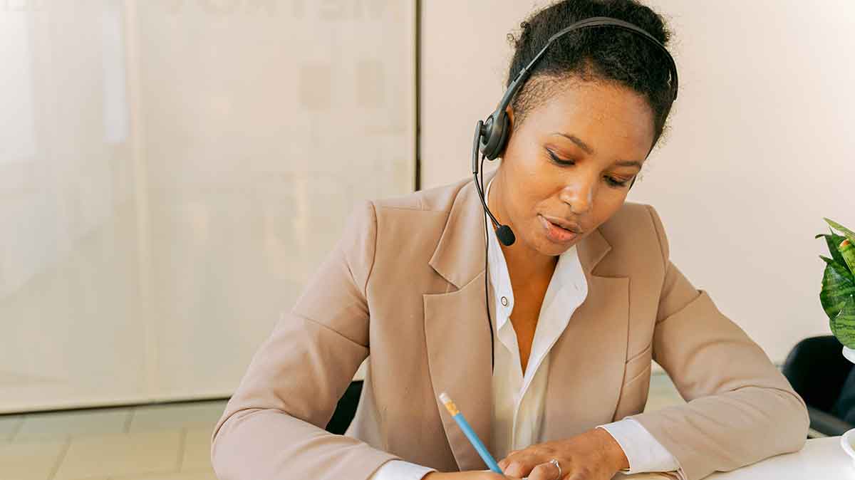 Telephone interpreter working remotely at desk.