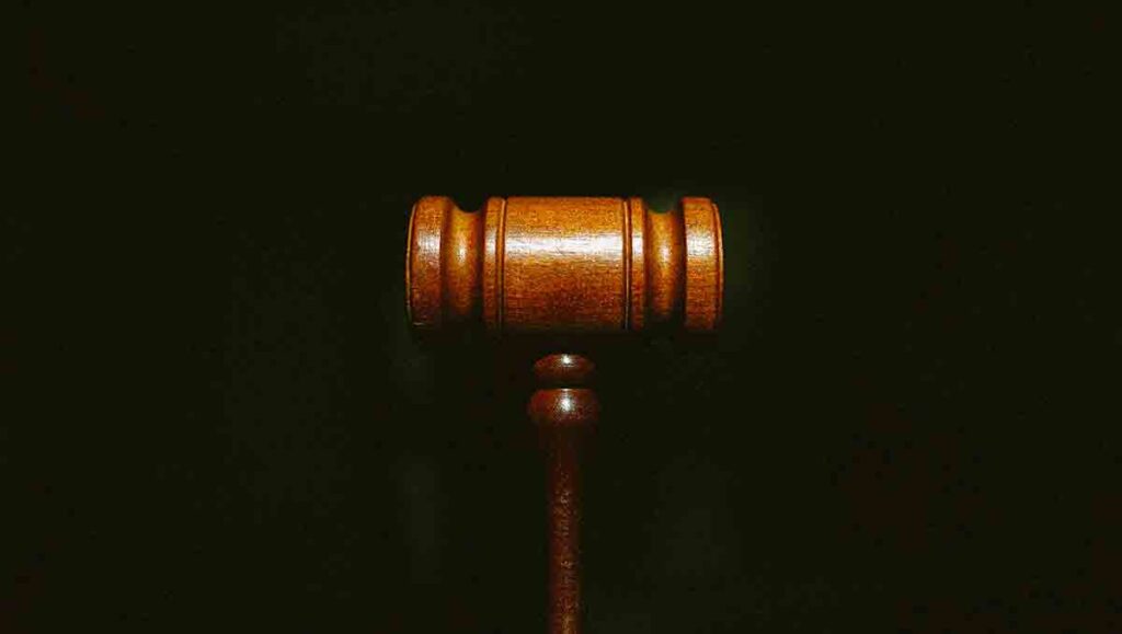 Close up of  brown gavel on a black background. 