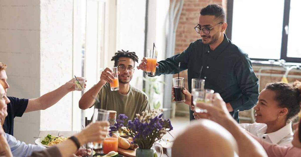 Group of friends gathering to share what they are thankful for and toasting to each other