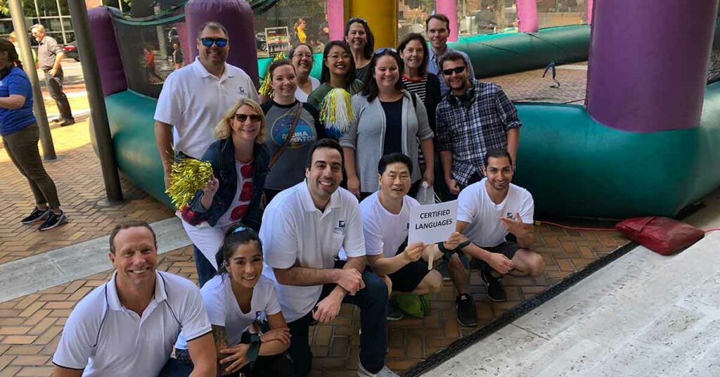 Group of employees from CLI smiling after win at human foosball tournament 