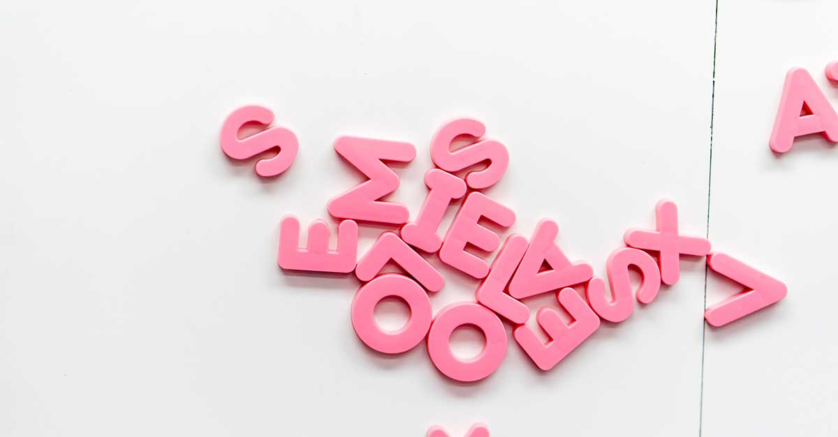 Pink letters mixed together on white background used to make acronyms