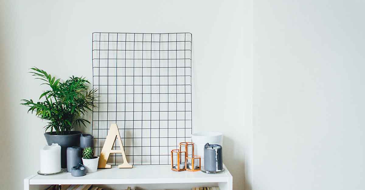 White desk for an interpreter with plants and candles to help create an inspiring environment.