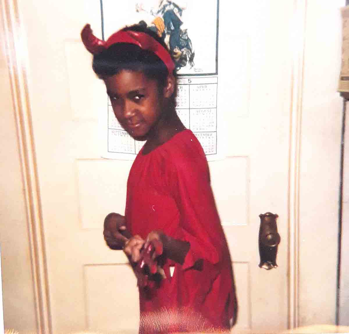 Rochelle as a little girl dressed as a red devil for Halloween.