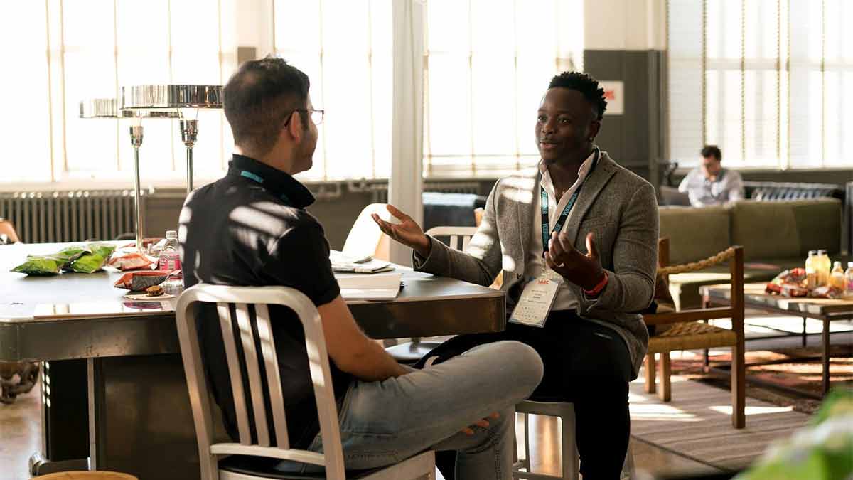 A businessman works with a professional interpreter to speak with a client.