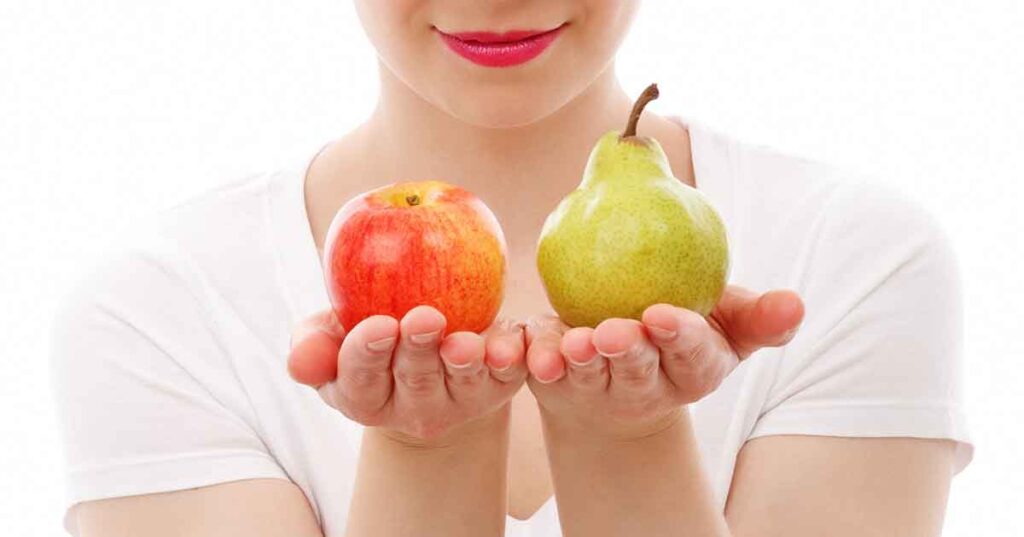 A person wearing a white shirt comparing the difference between an apple and a pear, much like you could compare the differences between and interpreter and a translator.