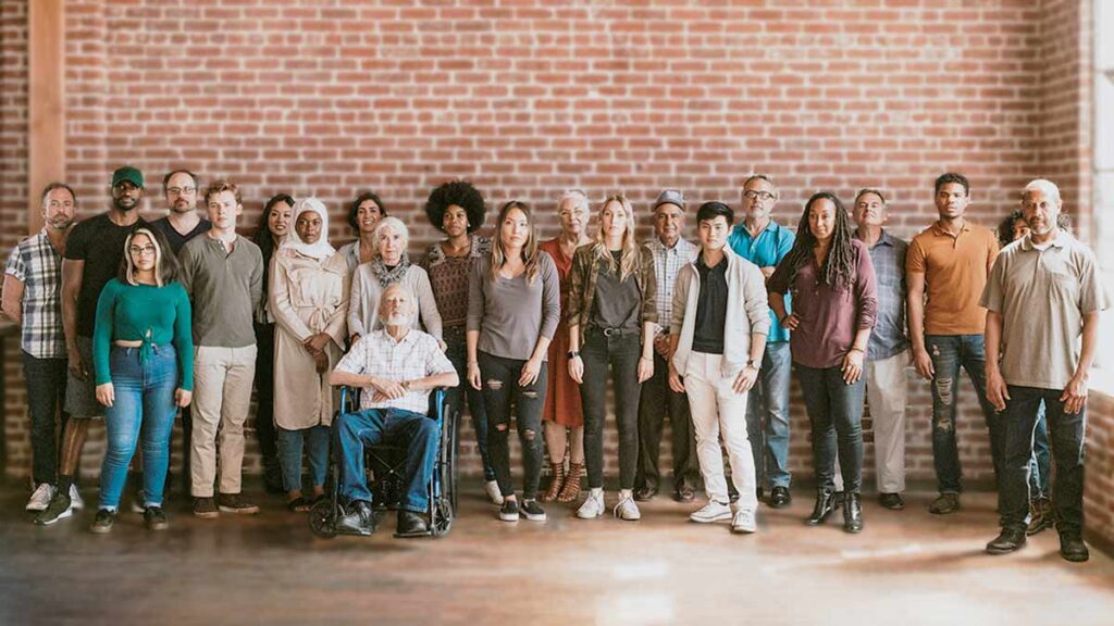 A diverse group of people stand strong together in support of language access.