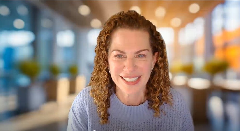 Director of Language Access Debbie Lesser smiles in front of generic Zoom background during our interview with her about patient safety.