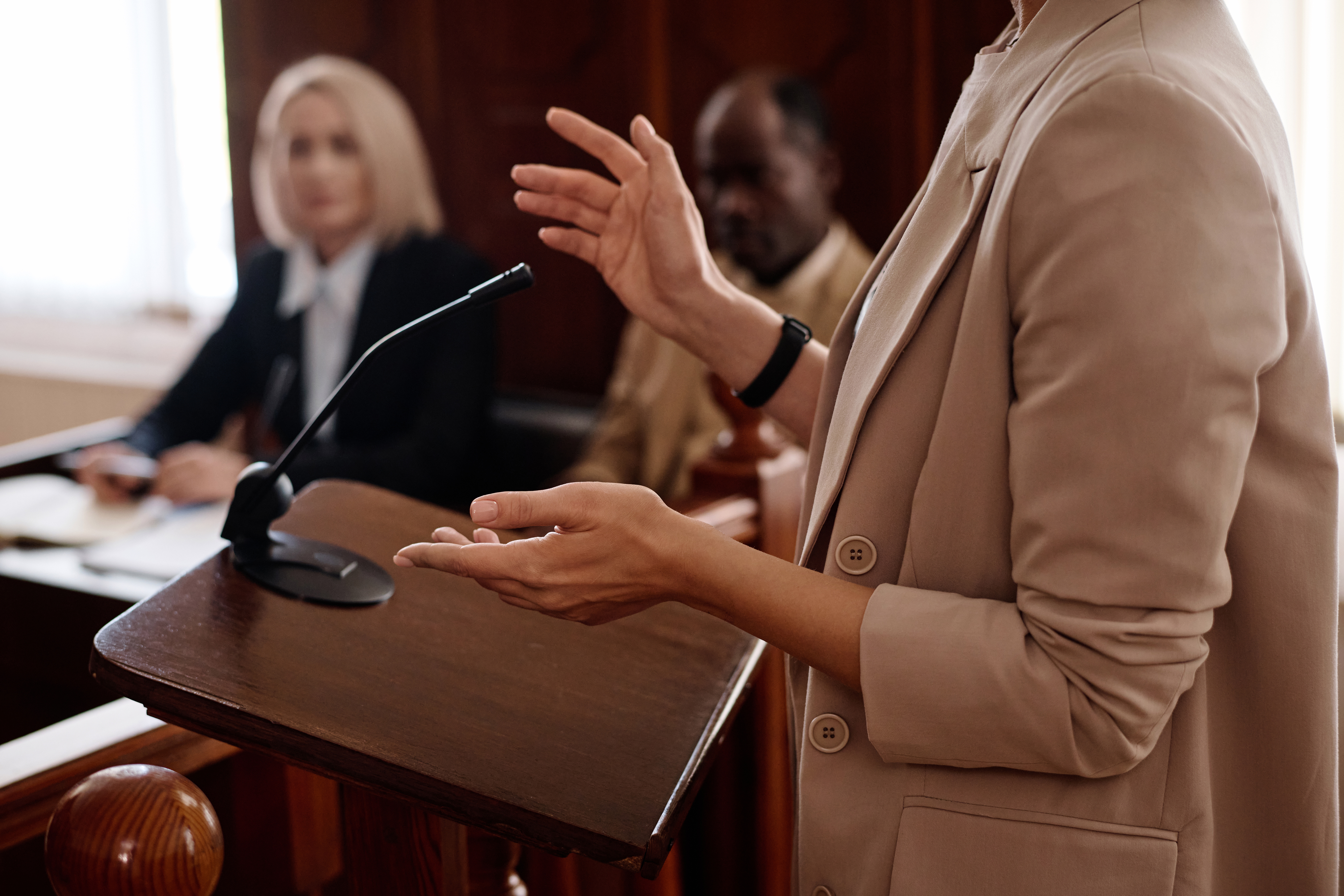 Individual speaking into a microphone during a hearing so the remote court interpreter can hear